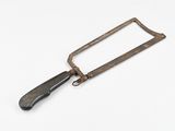 an old metal hand saw with a wooden handle on a white surface