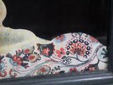 a picture of a painting of a woman laying on a bed