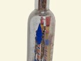 a small bottle with a lot of candy inside of it