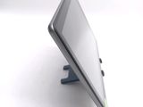 a tablet computer sitting on a stand on a white surface