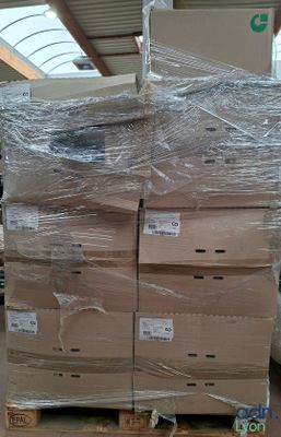 a large stack of boxes sitting on a pallet in a warehouse