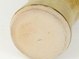 a close up of a vase on a white surface