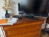 a television on top of a wooden dresser in a room