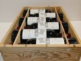 bottles of wine in a wooden box on a white surface