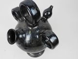 a black vase that has three black vases on it