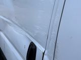 a white van that has been vandalized and is parked