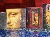cinq livres posés sur une table recouverte d'une nappe bleue