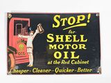 a sign that says stop for shell oil at the red cabinet
