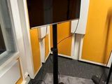 a flat screen tv sitting on a stand in a room