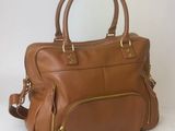 tan leather handbag with zippers and gold hardwares