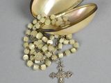 a rosary and a shell with a cross on it