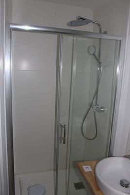 a bathroom with a shower, sink and toilet in it