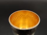 a silver cup that is sitting on a table