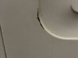 a piece of paper taped to the side of a toilet