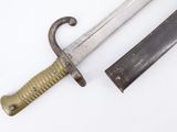 a knife that is sitting next to a knife on a table