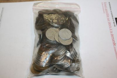 a bag of coins sitting on top of a piece of paper