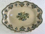 a plate with a floral design on it on a table