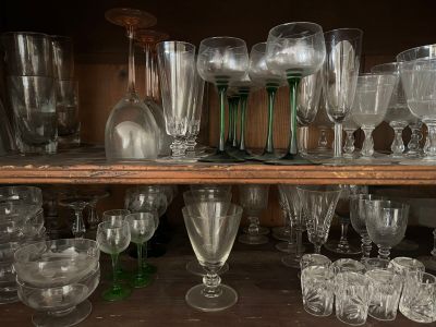 many glasses on a shelf in a room