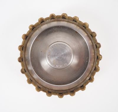 a close up of a metal object on a white surface