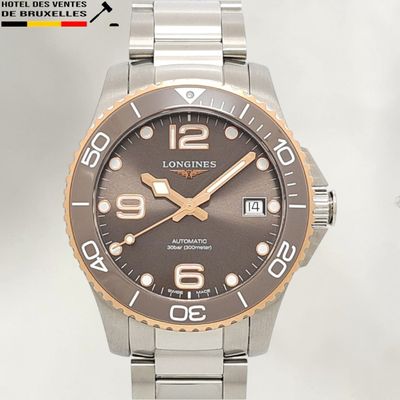 a picture of a longines watch with a brown dial