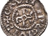 a silver coin with an image of a horse on it