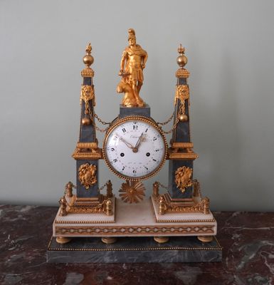 a clock that is sitting on top of a marble table