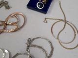 many different types of necklaces and bracelets laid out on a table