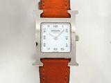 a silver watch with a brown leather strap on a white background