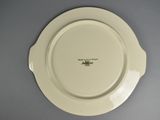 a white plate with a brown design on it