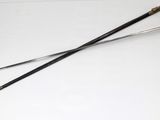 two swords on a white table with a black handle