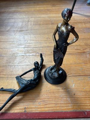 une statue en bronze représentant une femme et un homme sur un bateau