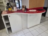 an image of a kitchen with a red counter top and white cabinets