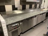 a man standing in a kitchen next to a counter