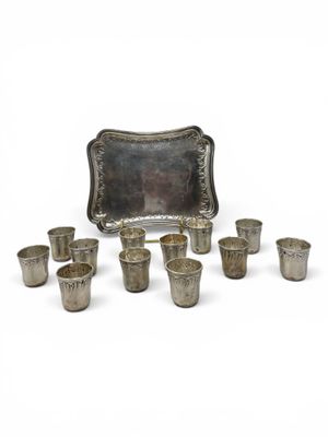 an image of a group of silver cups and trays on a white surface