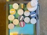 a drawer full of paint and supplies on the floor