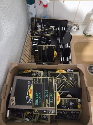 a lot of books in a box on the kitchen counter