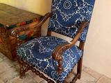 a blue and white chair sitting in front of a trunk
