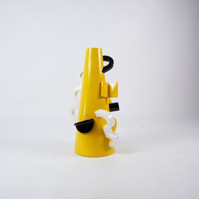 a yellow telephone that is on a white surface