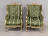 pair of green and gold painted armchairs with gold trim