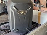 a suitcase sitting on top of a cart in a garage