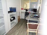 a desk with a chair and a computer on it