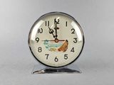 a clock with a picture of a fish and a bird on it