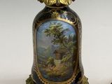 pair of vases with a painting on them sitting on a table