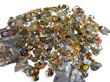a pile of assorted metal items on a white surface