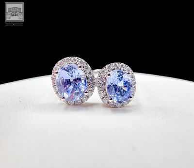 pair of tanzane and diamond earrings on a white plate