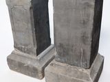 two stone pedestals sitting next to each other on a white surface