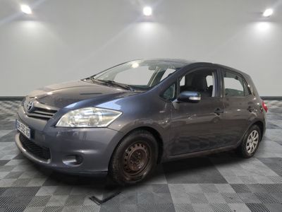a picture of a grey car parked in a garage