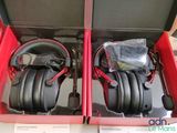 two black headphones in a red box on a table