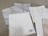 a lot of white napkins sitting on a couch