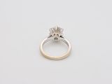 a close up of a diamond ring on a white surface